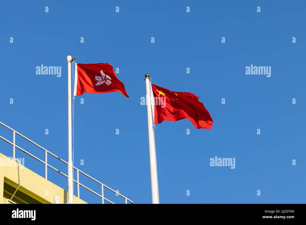 National flag of People’s republic of China and regional flag of Hong Kong Special Administrative region Stock Photo