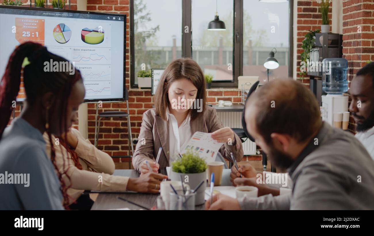 Diverse group of workmates discussing business strategy in startup ...