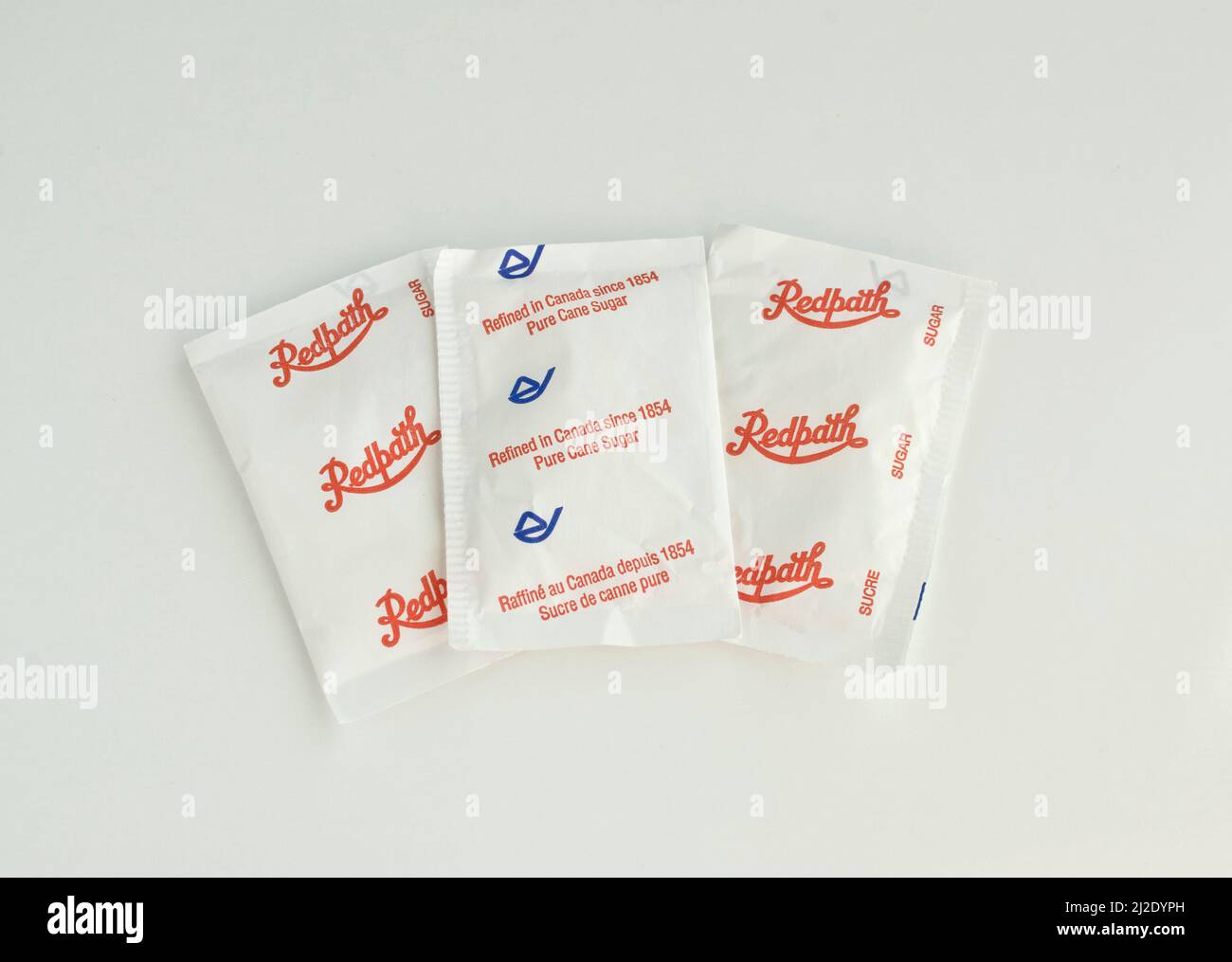 Packets of white sugar.  Sugar packages by Redpath Canadian sugar company. Stock Photo