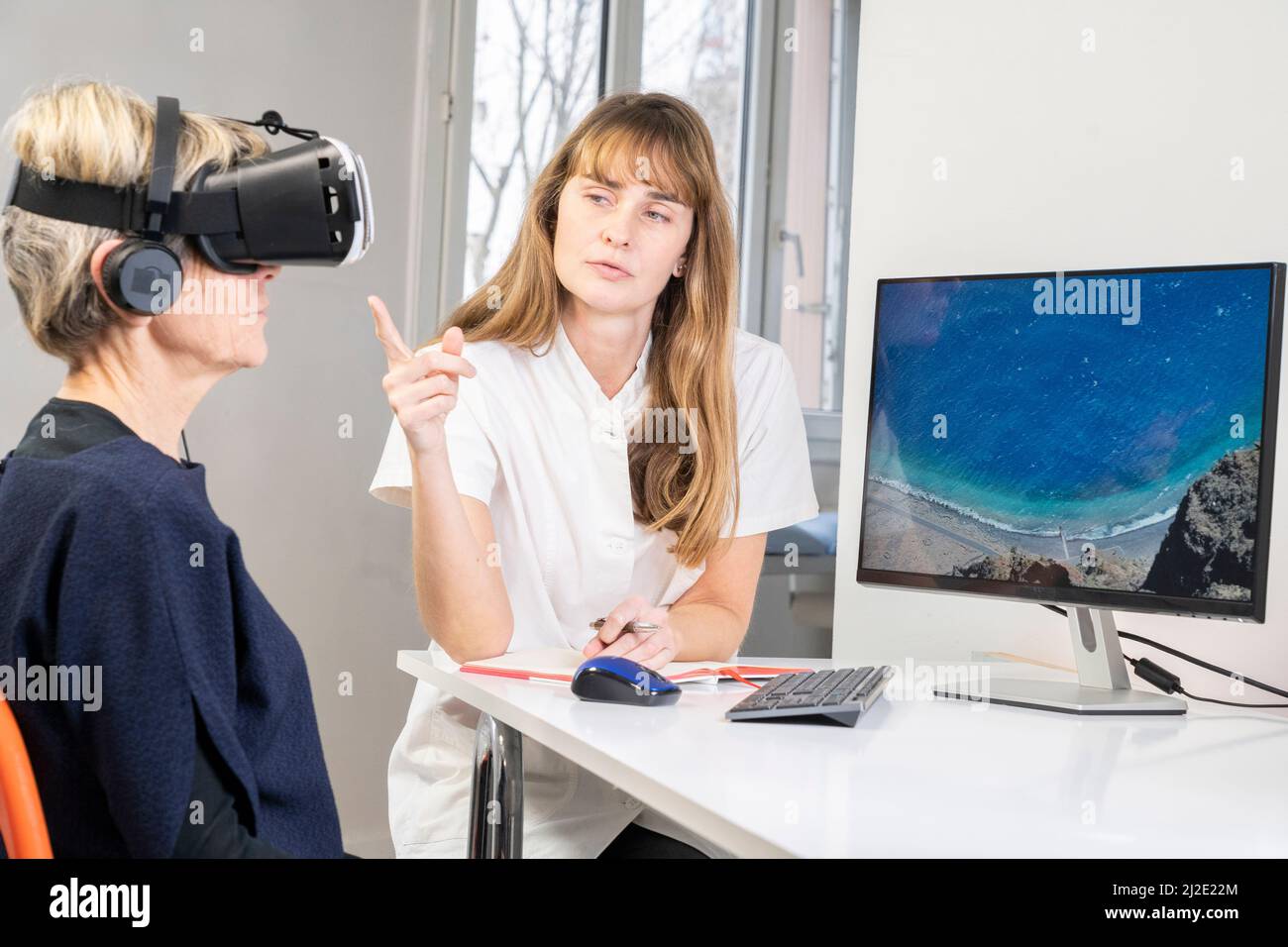 Elderly woman in virtual reality headset Stock Photo