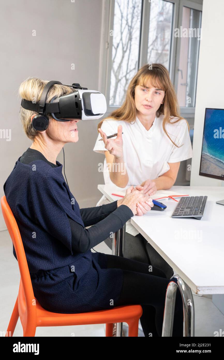 Elderly woman in virtual reality headset Stock Photo - Alamy