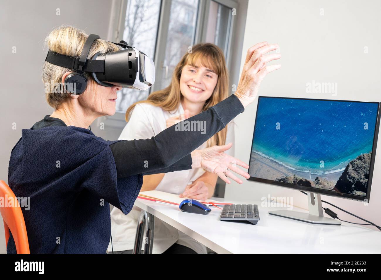 Elderly woman in virtual reality headset Stock Photo Alamy