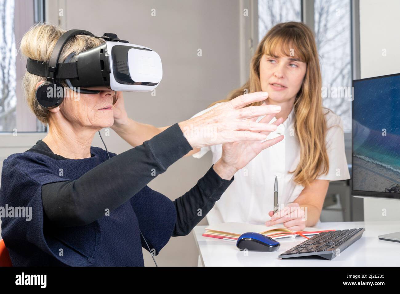 Elderly woman in virtual reality headset Stock Photo Alamy