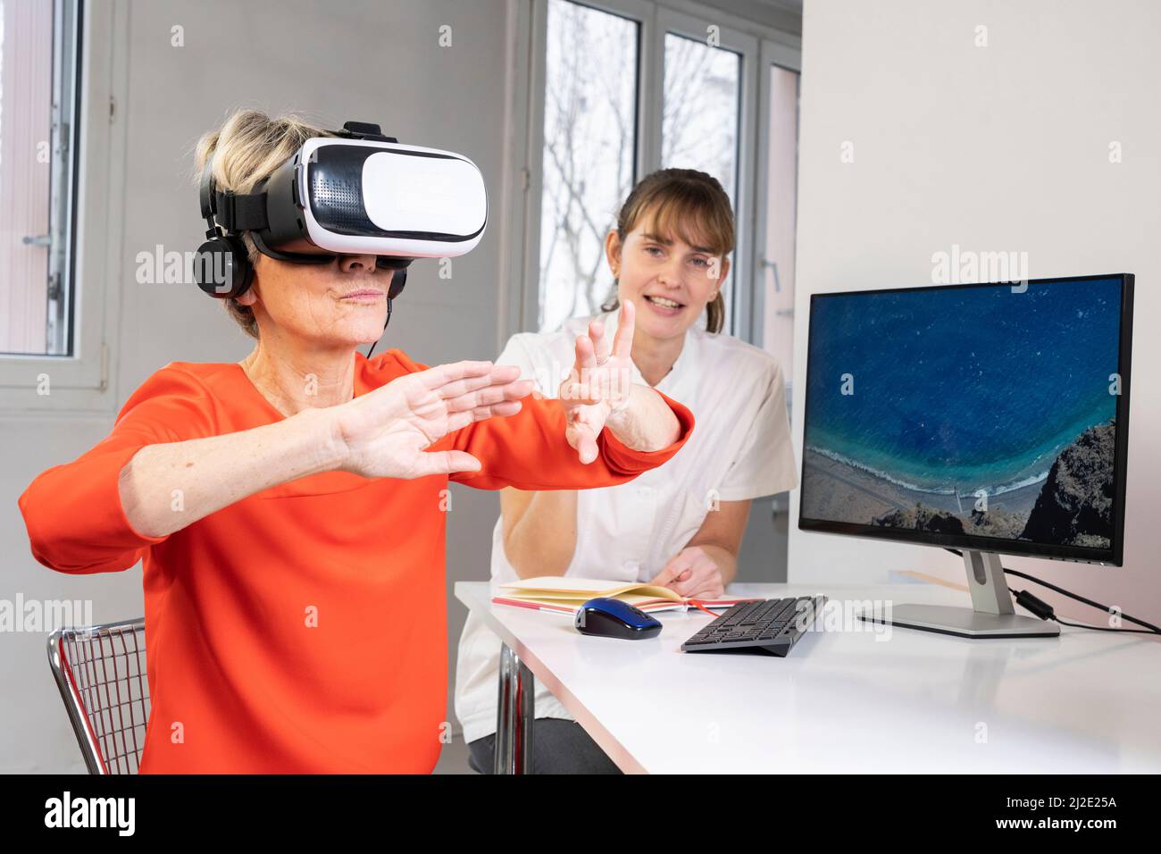 Elderly woman in virtual reality headset Stock Photo Alamy