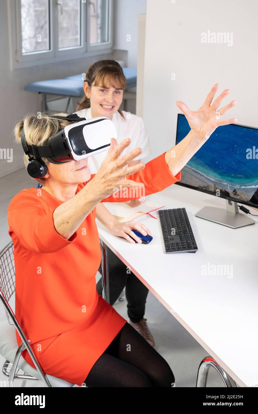 Elderly woman in virtual reality headset Stock Photo Alamy