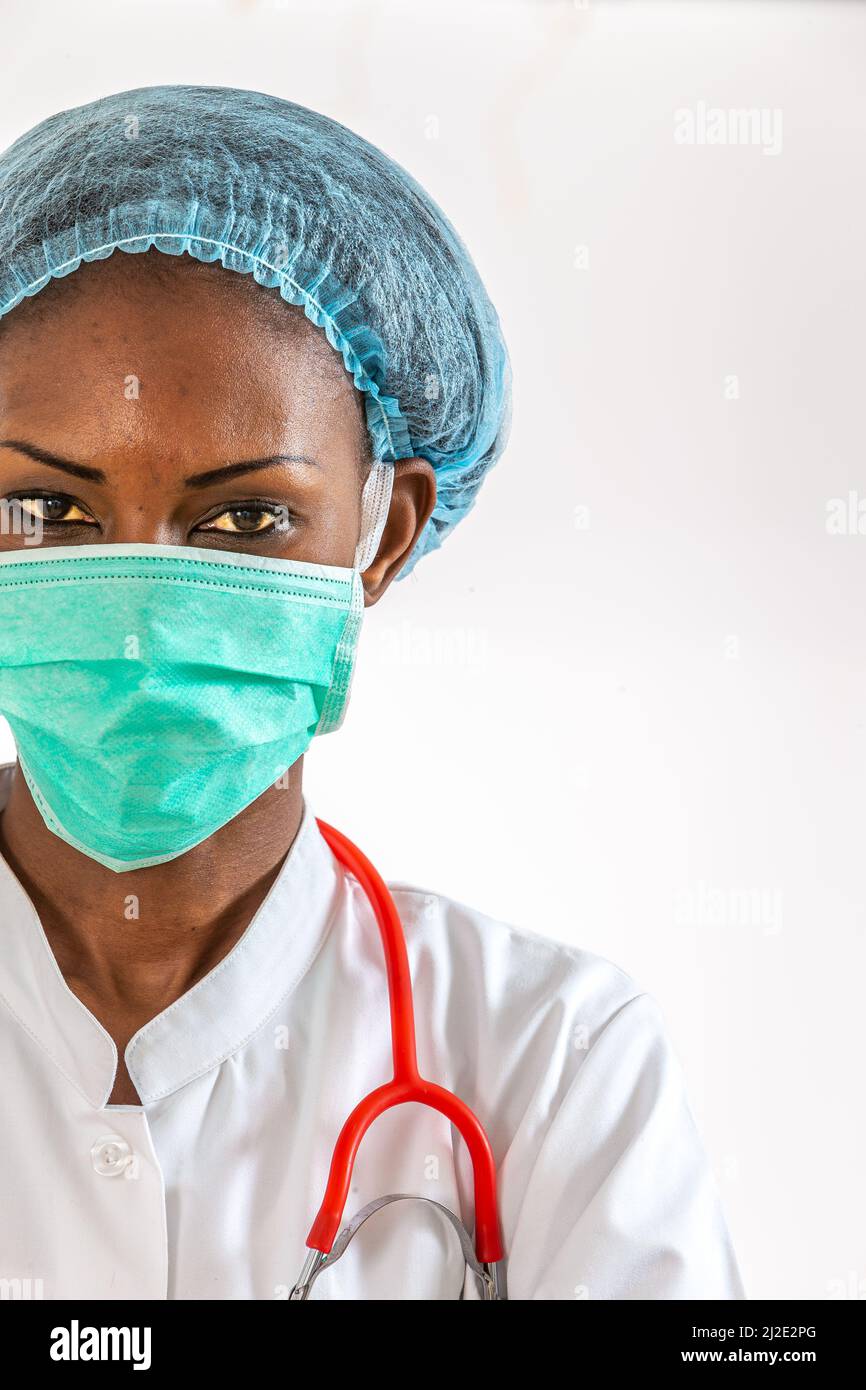 Female american african doctor, nurse woman wearing medical coat ,cap, with stethoscope and mask. Stock Photo