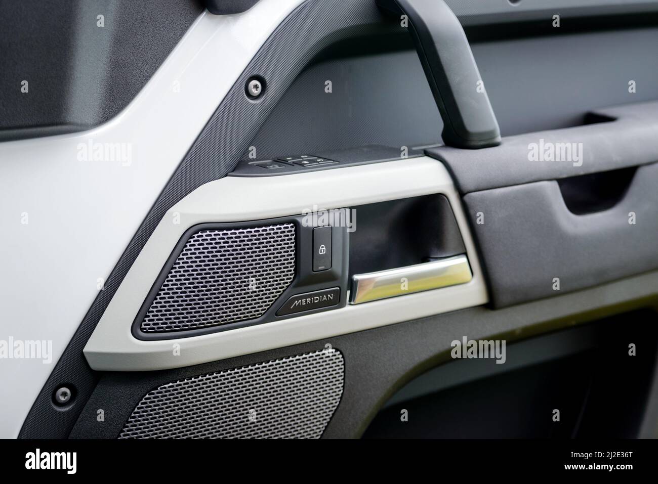Russia, Rostovskaya oblast, 2021 June 09: Close up of Meridian speaker on car door panel in new Land Rover Defender. Stock Photo