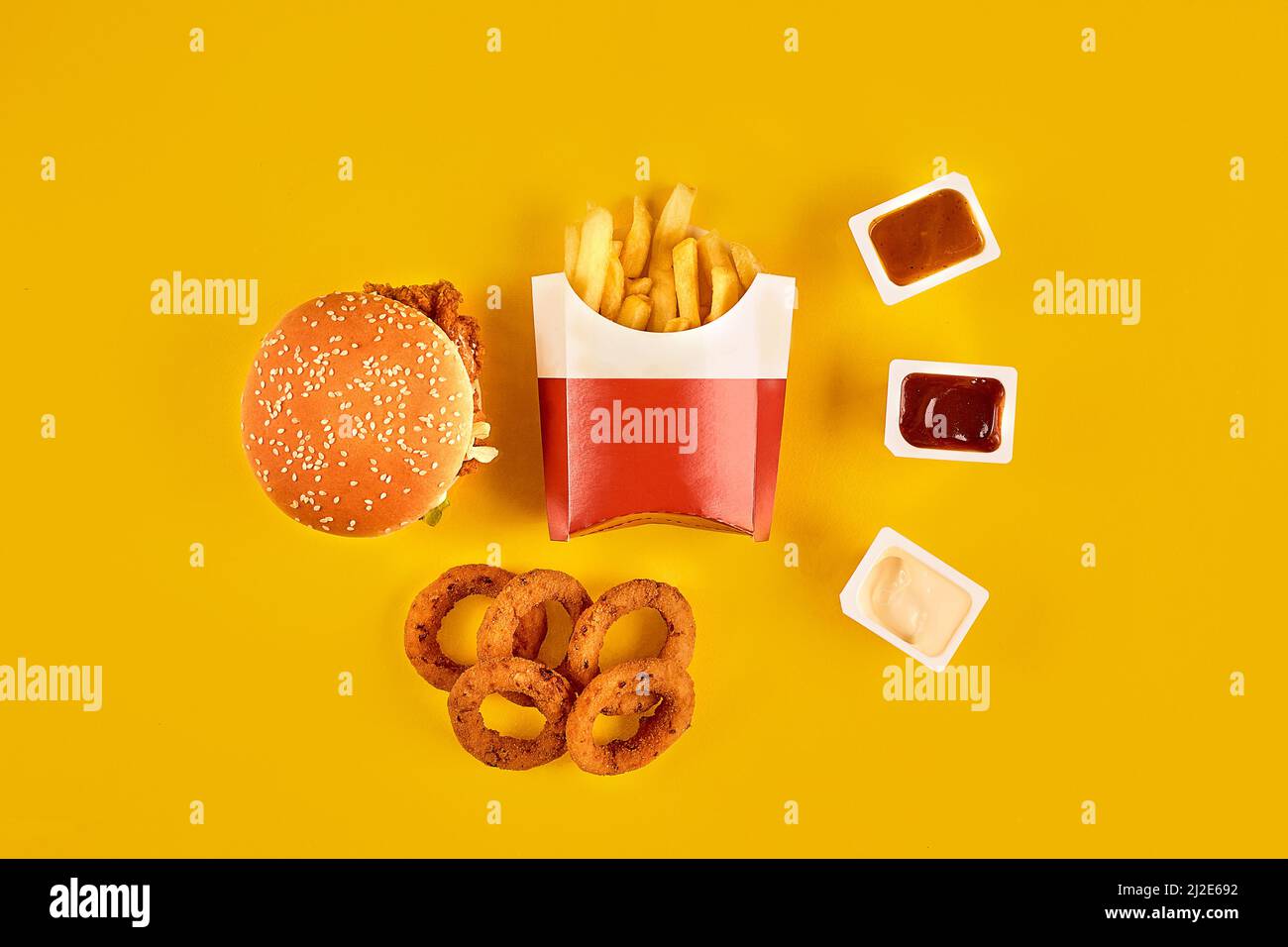 Fast food dish top view. Meat burger, potato chips and wedges. Take