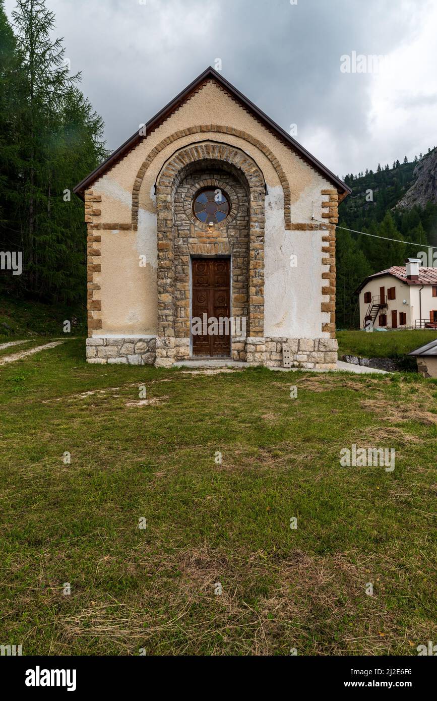 Stone chapel in Pian di Falzarego bellow Passo Falzarego in the Dolomites Stock Photo