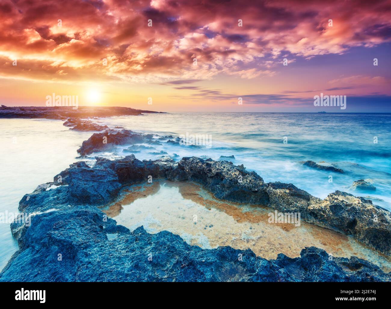 Amazing morning sun over the sea. Dramatic scenery. Volcanic island of