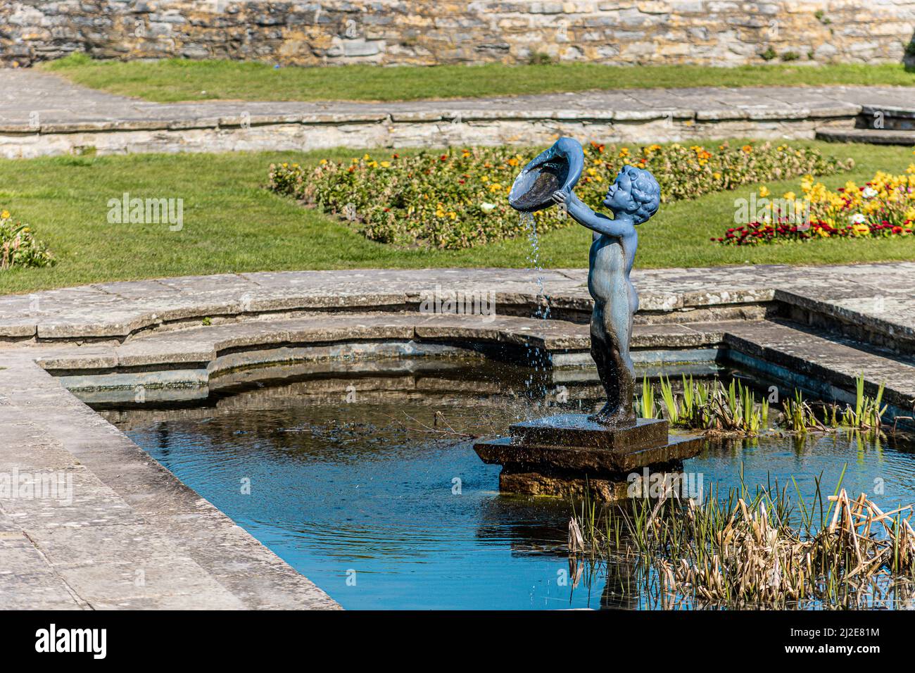 Statue of a Cherub  fountain in a pond at marine cove gardens at Burnham on sea, Somerset, United Kingdom Stock Photo