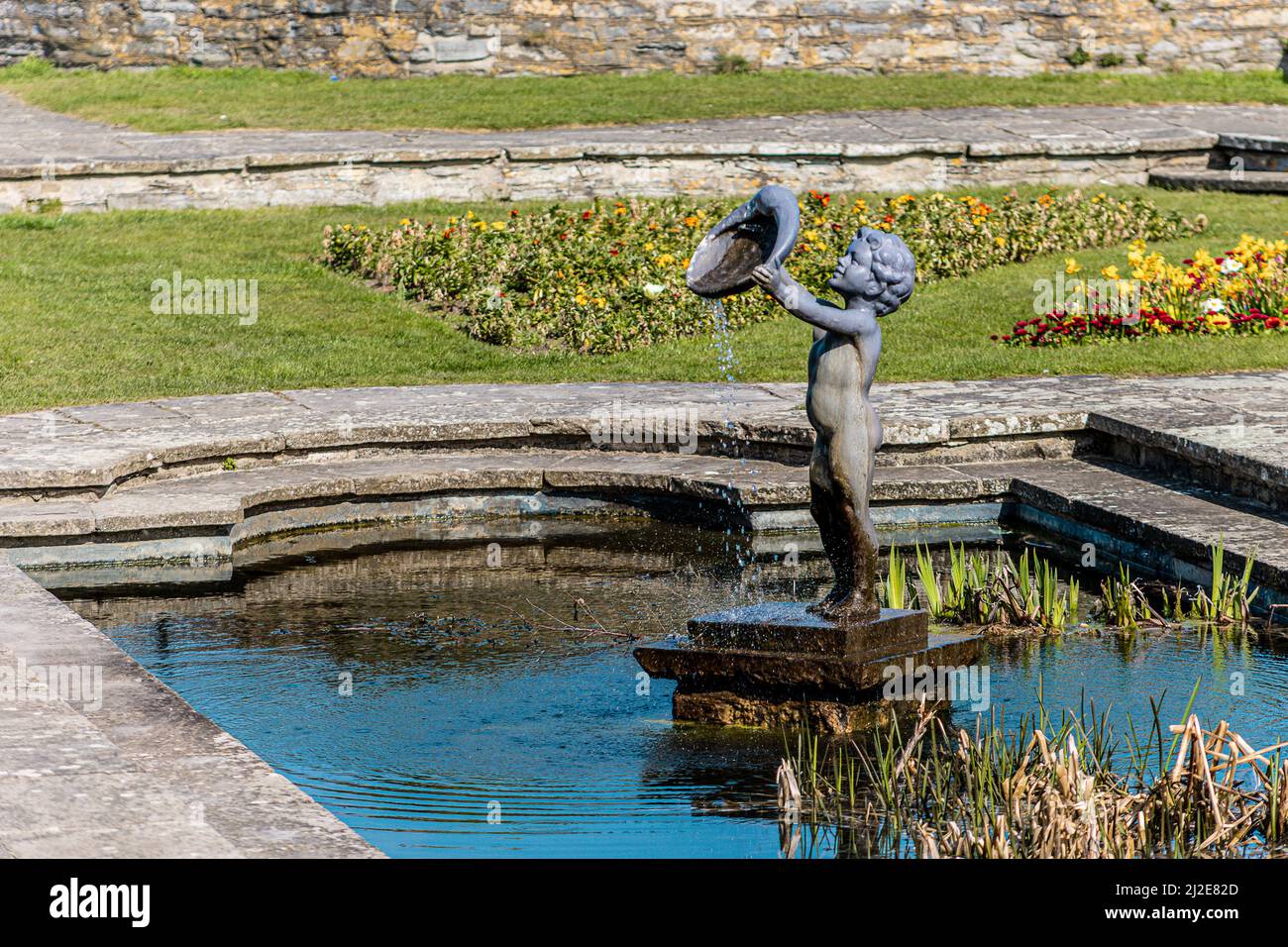 Statue of a Cherub  fountain in a pond at marine cove gardens at Burnham on sea, Somerset, United Kingdom Stock Photo