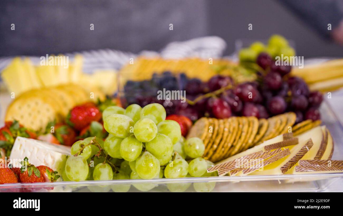 Step by step. Arranging cheese platter with fresh fruits, gourmet