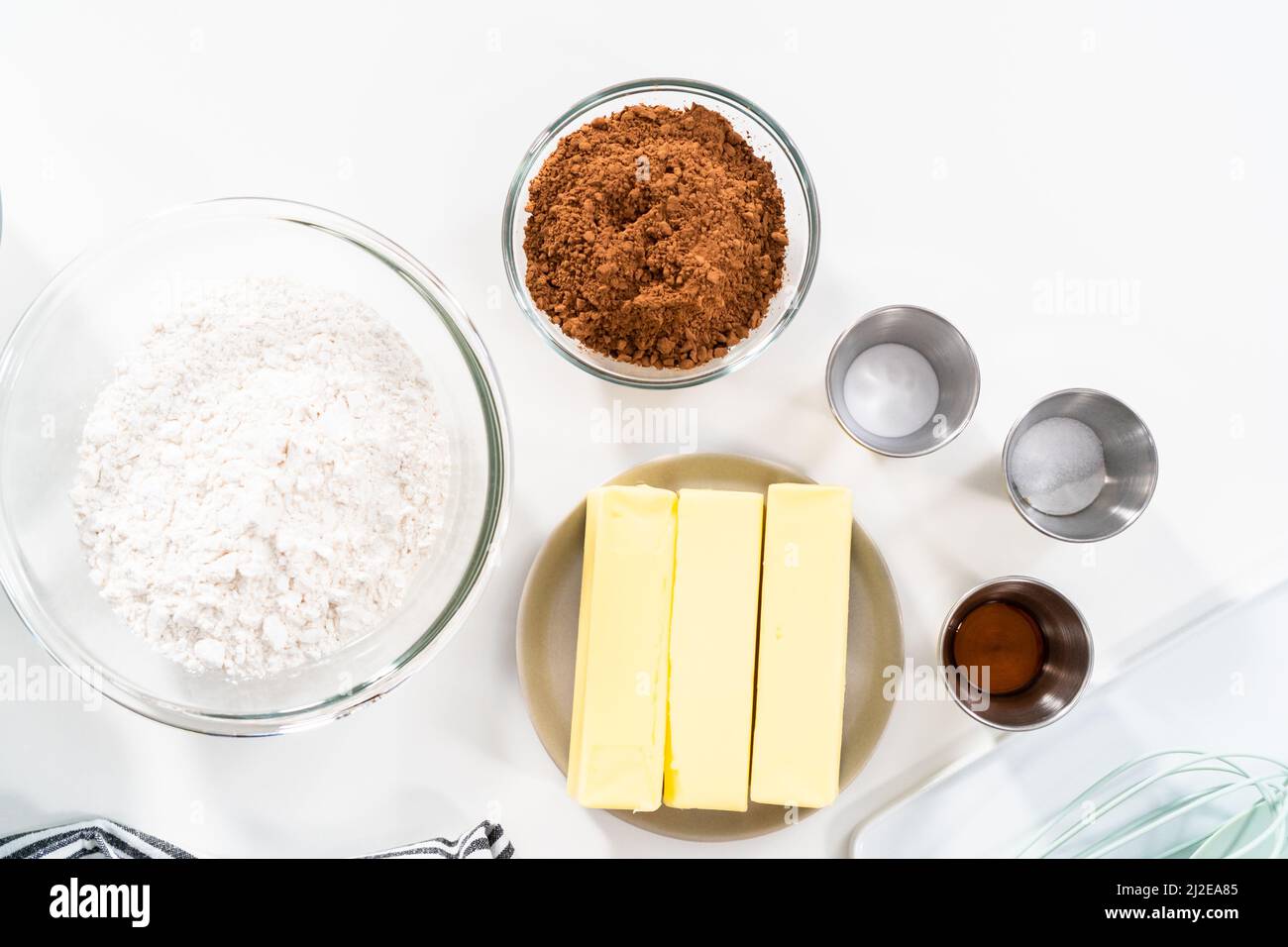 Ingredients in mixing bowls on the counter to bake chocolate cookies