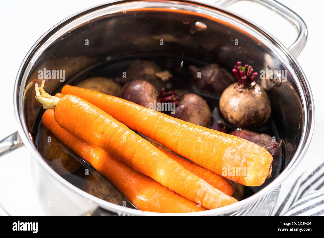 Boiling vegetables in a big cooking pot to make a vinaigrette salad