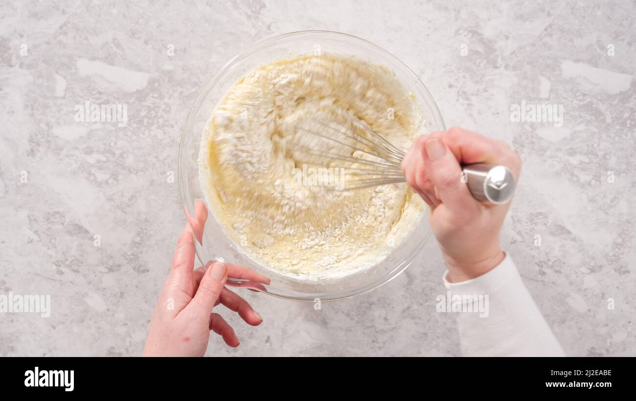 Flat lay. Step by step. Mixing ingredients in a glass mixing bowl to