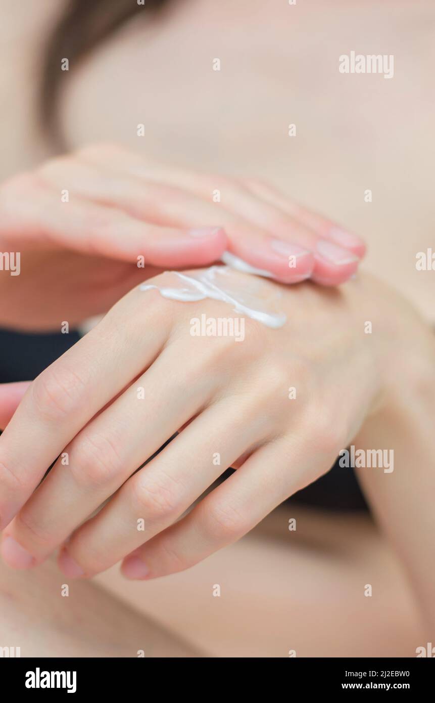 Close-up of female hands with moisturizer. A woman applies cream to her hands. Hand and whole body care Stock Photo