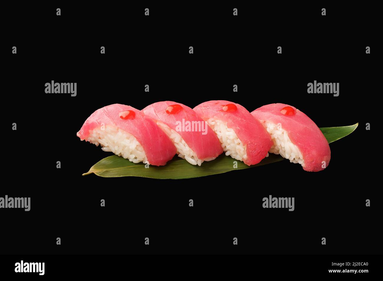 Nigiri sushi tuna with sriracha sauce, banana leaf. japanese food on