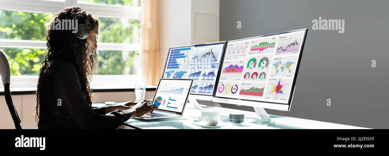 African Advisor Using KPI Dashboard With Financial Analytics Graphs Stock Photo