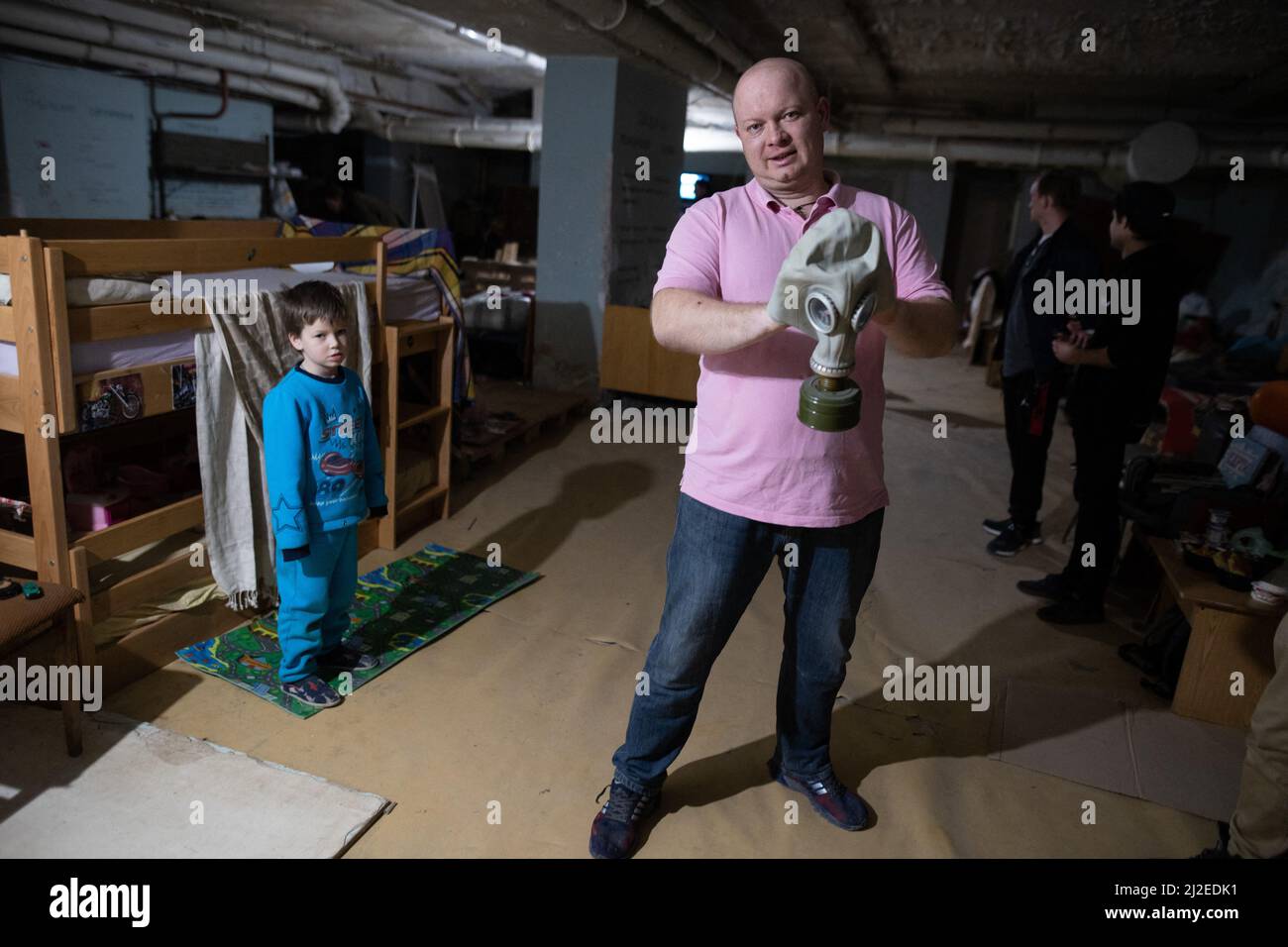 A man hold a Gas Mask as 50 People live in a Fallout shelter built during the Cold War in 1985 by USSR in Kyiv, (Kiev), on March 27, 2022 during the Russian Invasion of Ukraine. The Shelter is build under a public hospital in Obolon district and serve as a protection for civilian against Russian shelling. Photo by Raphael Lafargue/ABACAPRESS.COM Stock Photo