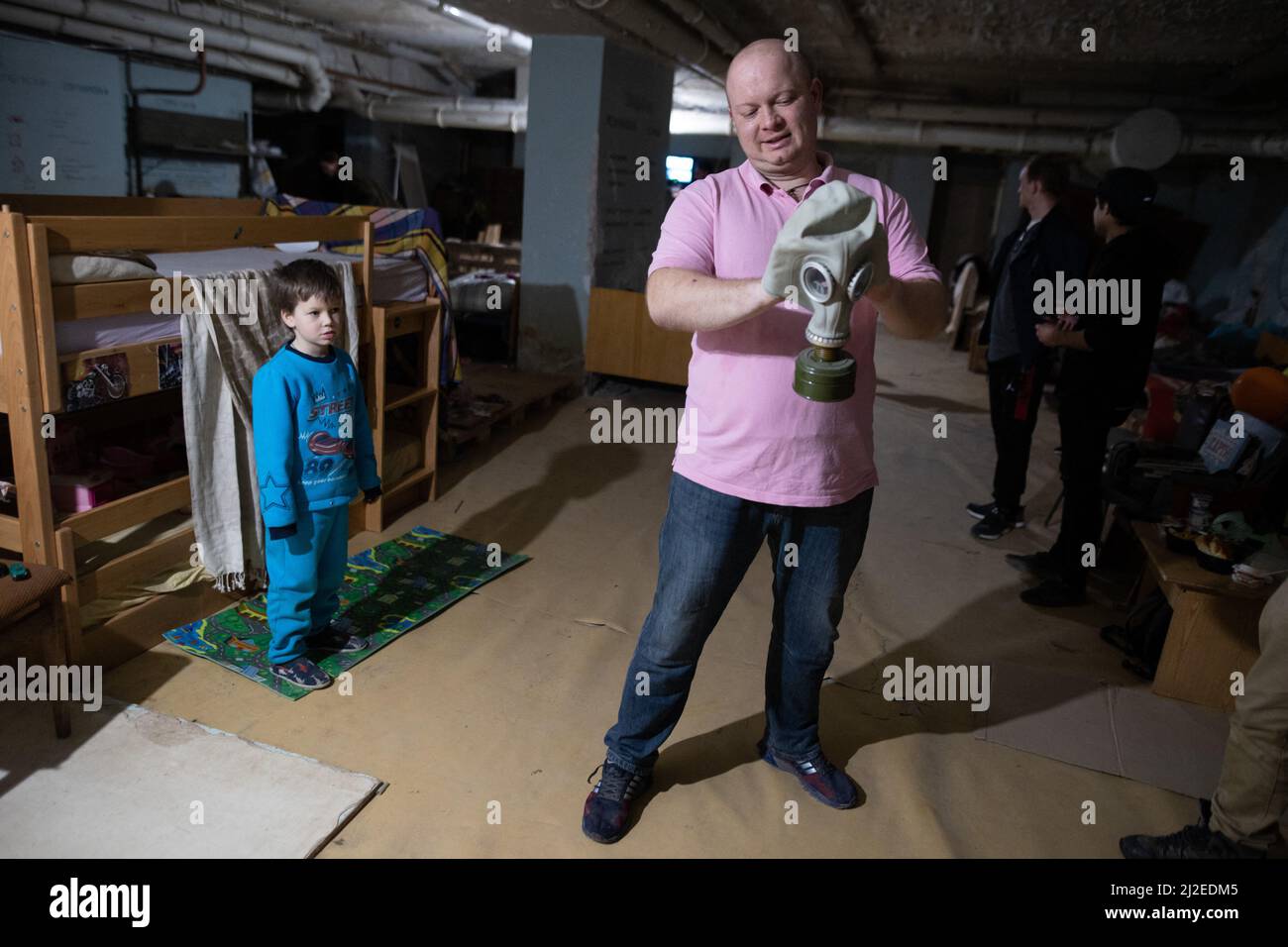 A man hold a Gas Mask as 50 People live in a Fallout shelter built during the Cold War in 1985 by USSR in Kyiv, (Kiev), on March 27, 2022 during the Russian Invasion of Ukraine. The Shelter is build under a public hospital in Obolon district and serve as a protection for civilian against Russian shelling. Photo by Raphael Lafargue/ABACAPRESS.COM Stock Photo