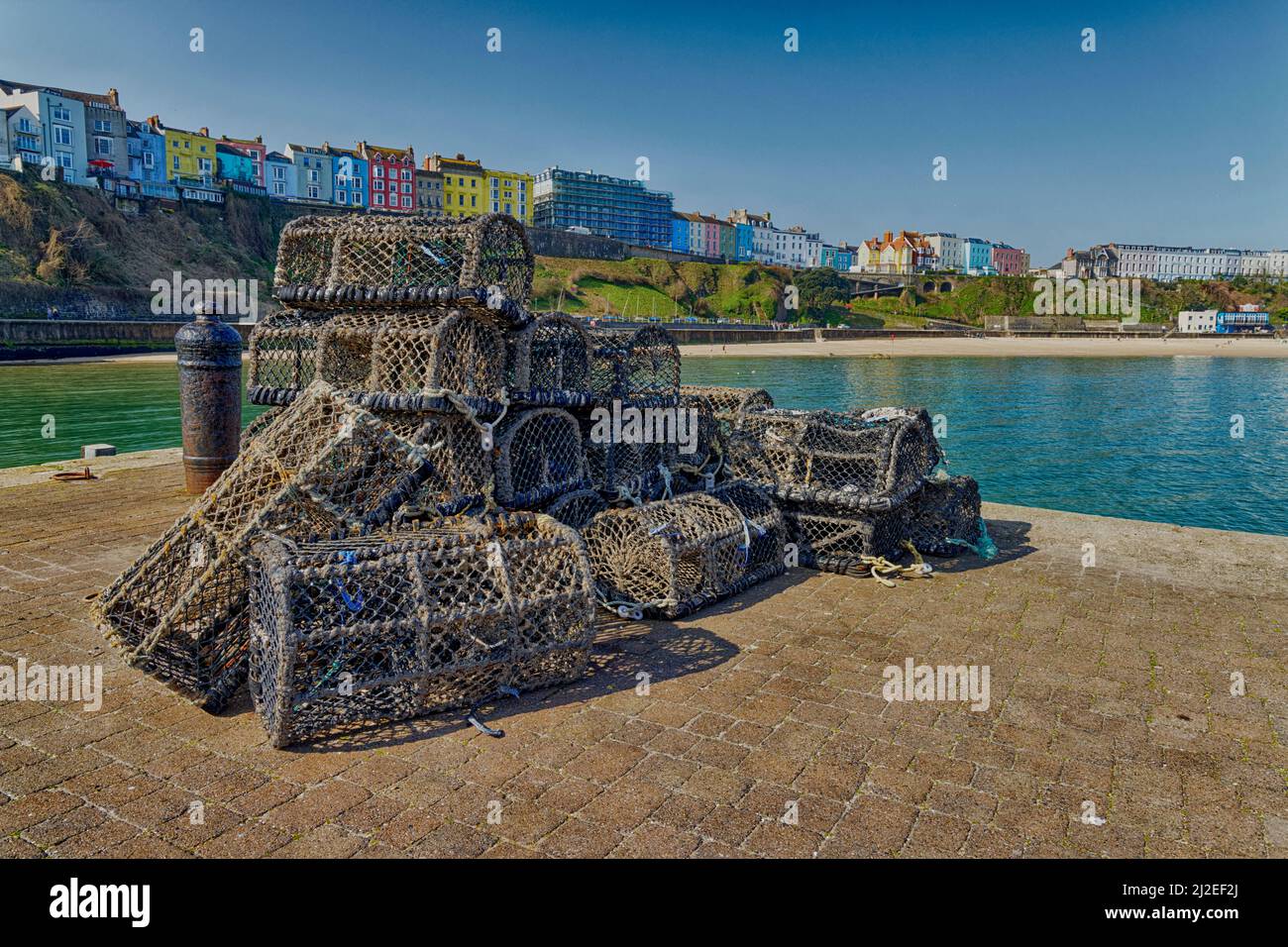 Lobster Pots on the quayside in Tenby Harbour Pembrokeshire SouthWest Wales Stock Photo