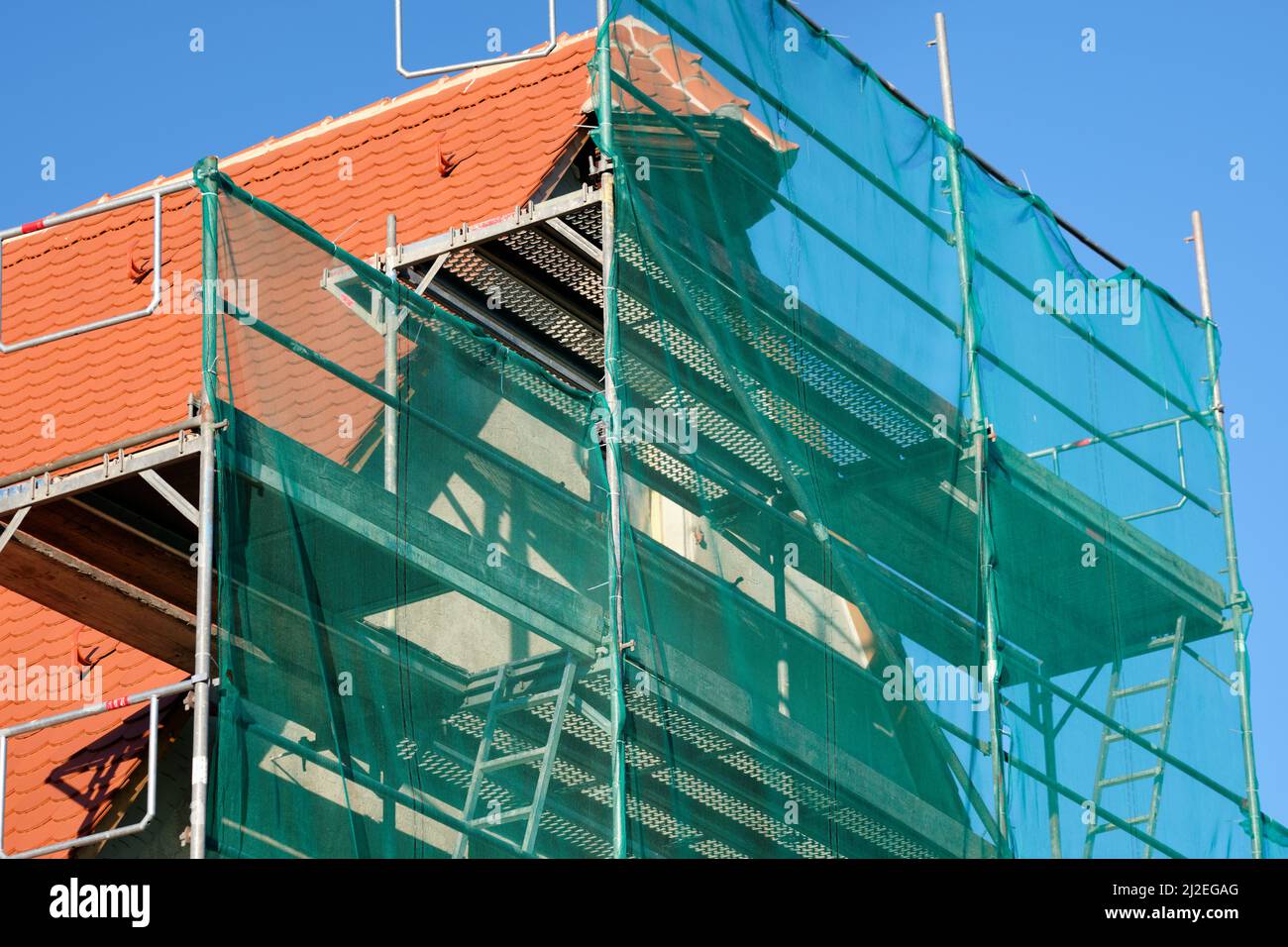 Nuremberg, Germany - March 14, 2022 : Close-up of  scaffolded facade of a historic barn building being renovated and having a new roof. Stock Photo
