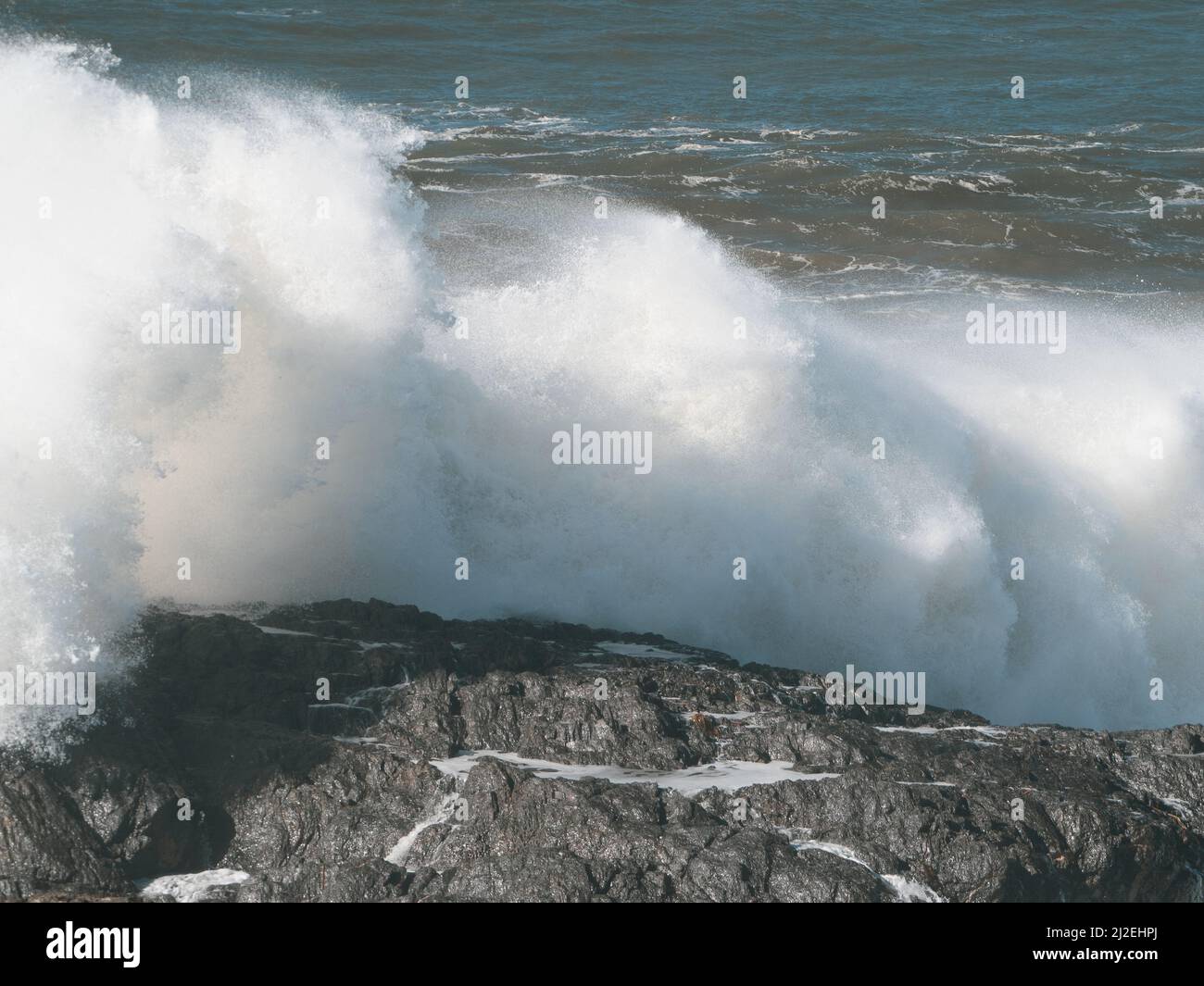 White waves, A wild sea wave crashing and smashing over rocks at the headland, powerful force of nature on display, Pacific Ocean, NSW, Australia Stock Photo
