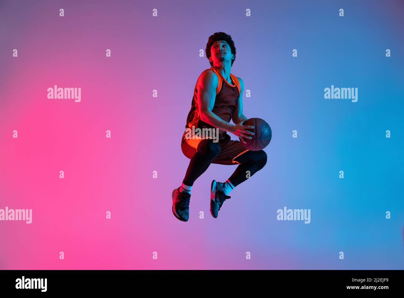 An energetic young man playing basketball Stock Vector by ©interactimages  46122663