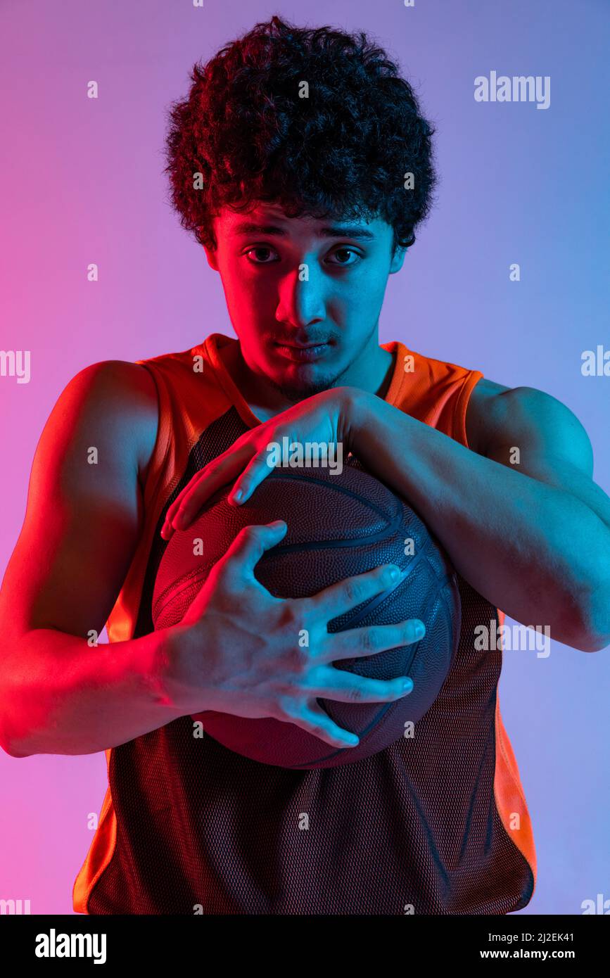 Young Man, Male Athlete in Motion Over Gradient Studio Background