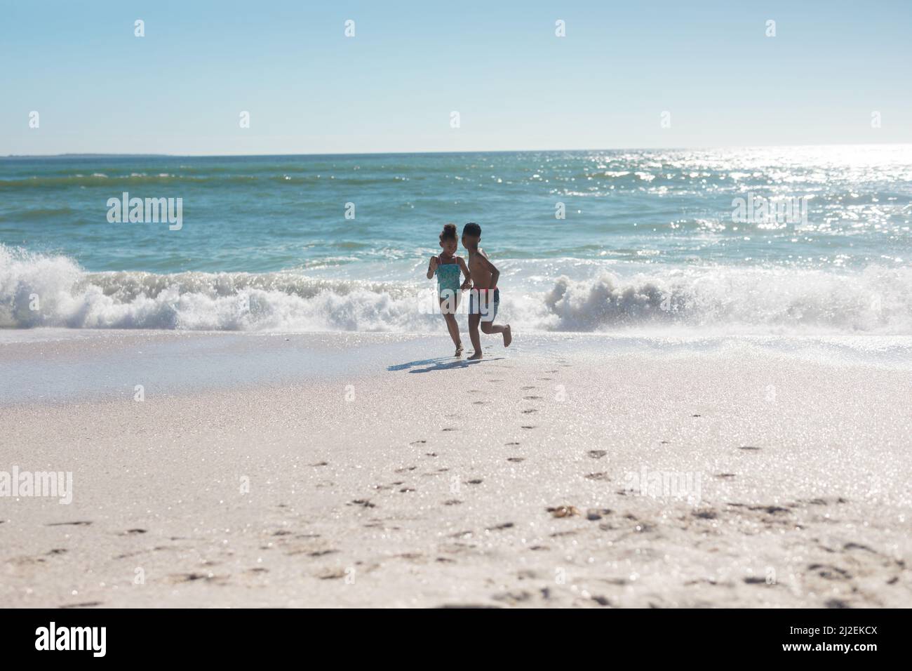 Siblings playing on the beach hi-res stock photography and images - Alamy