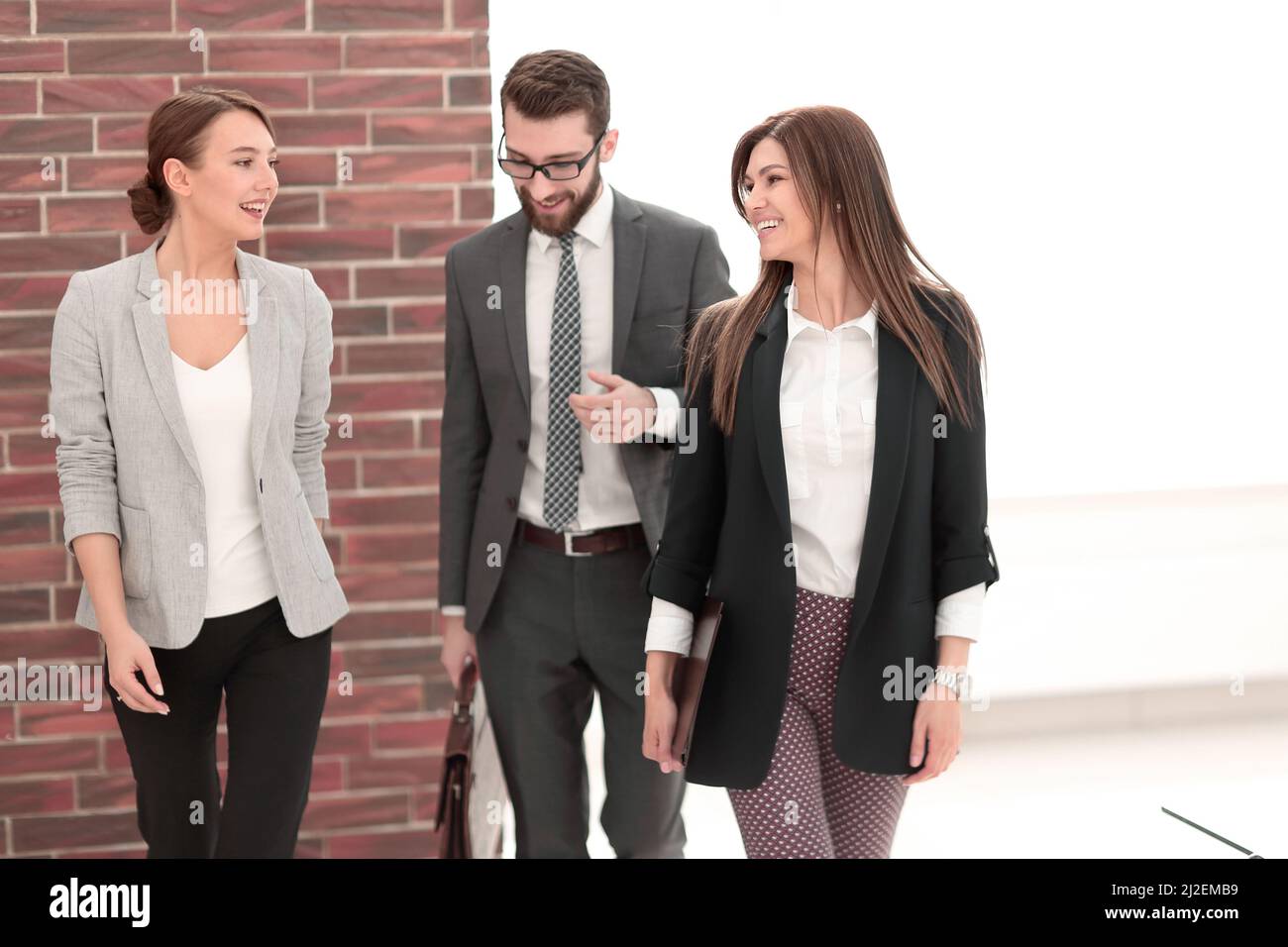 business team talking standing in the office Stock Photo - Alamy