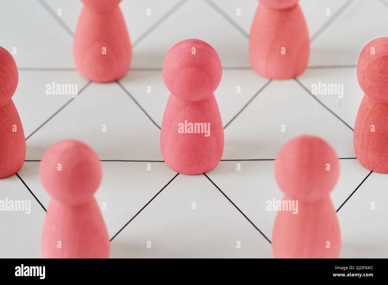 Pink pawns connected together - Concept of woman and teamwork Stock Photo