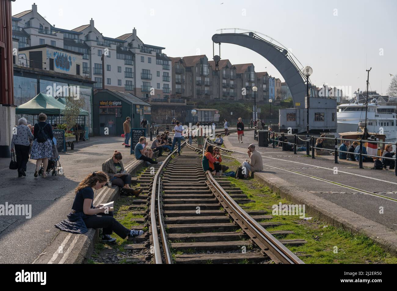 People spending leisure time at the harbour on a sunny day. Bristol, UK. Stock Photo