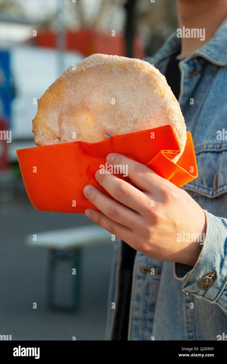 Italy, Lombardy, Hand Holding Frittes at Street Market Food Stock Photo