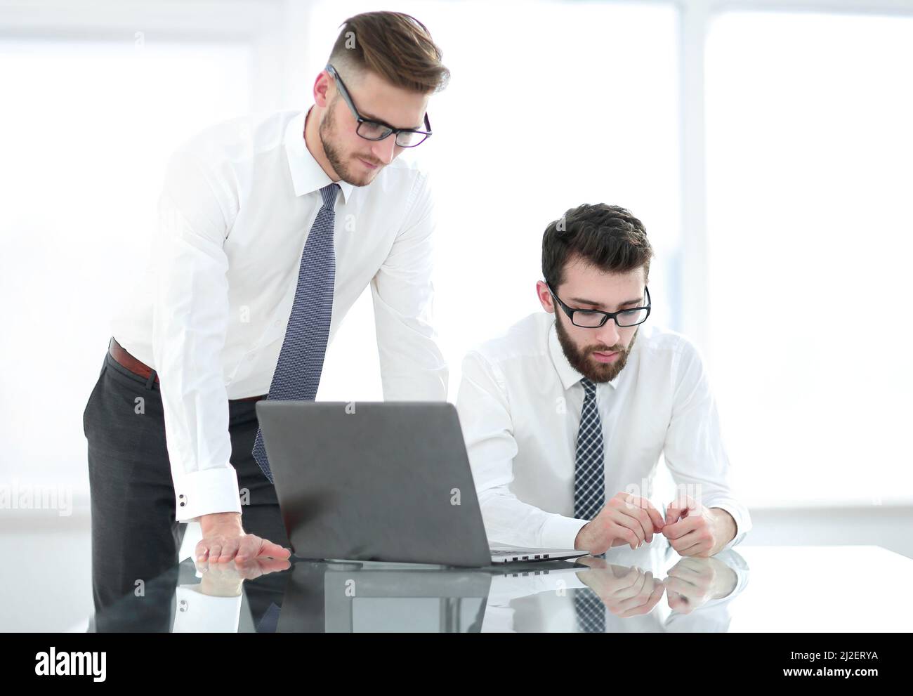 close up.two employees solving business problems Stock Photo - Alamy