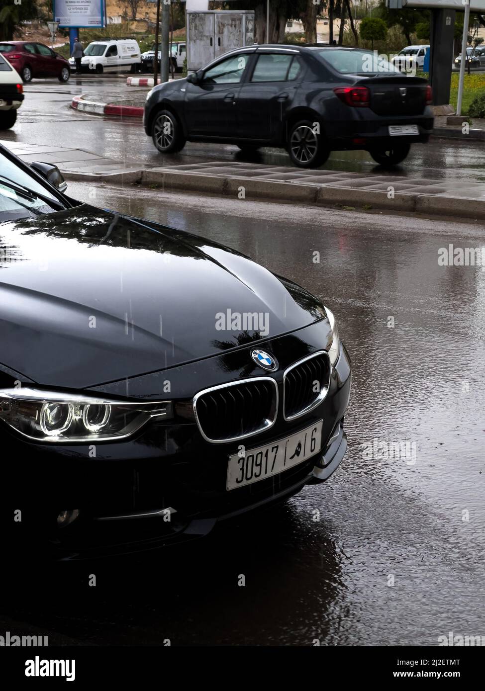BMW headlights turned on outdoors Stock Photo Alamy