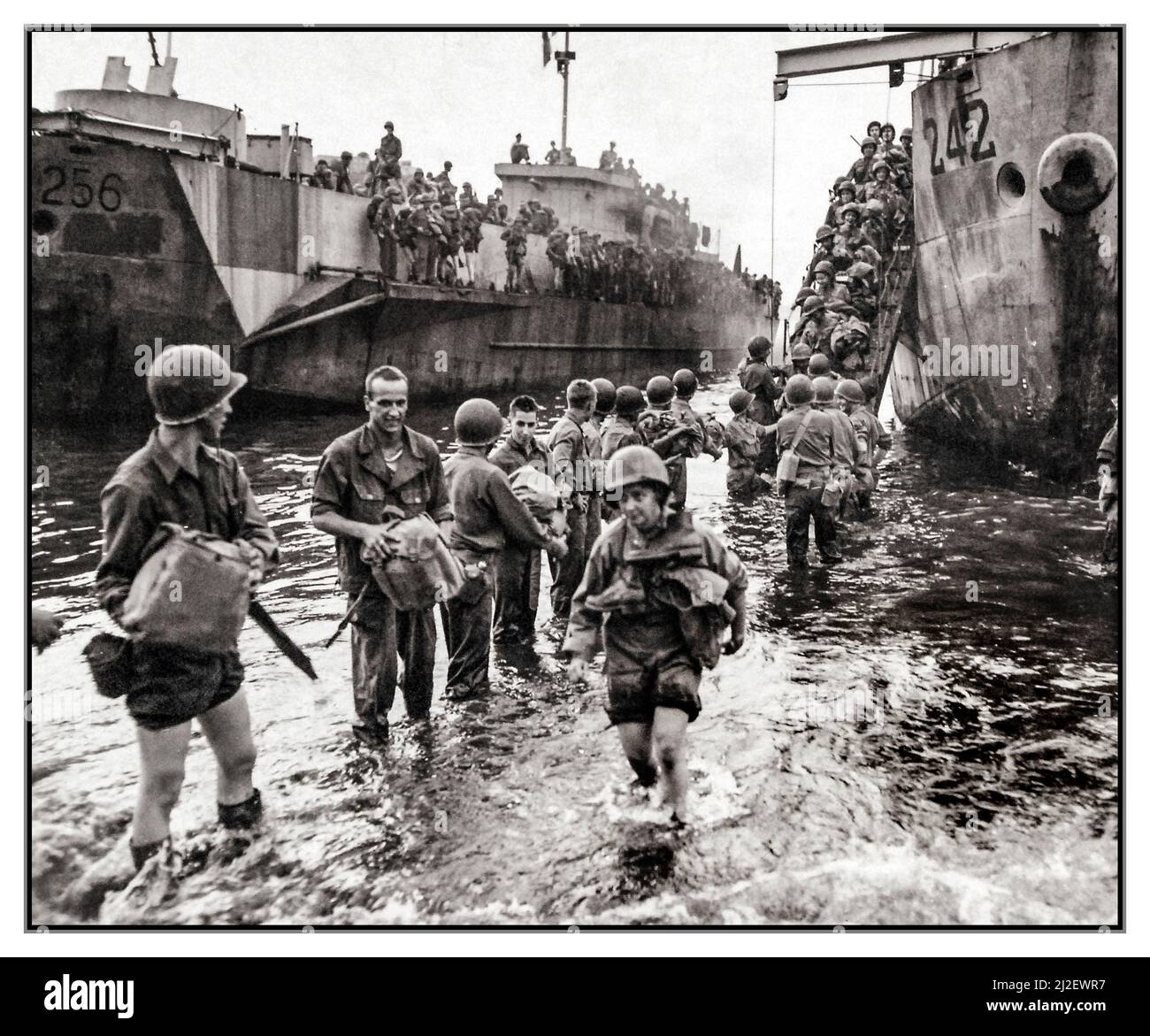 WW2 Italy Invasion Naples U.S. Army nurses and soldiers at Naples, Italy, wading ashore from LCI 242 during the September 1943 action. The nurse in the foreground carries her boots around her neck for safekeeping. November 4, 1943. U.S. Navy Stock Photo