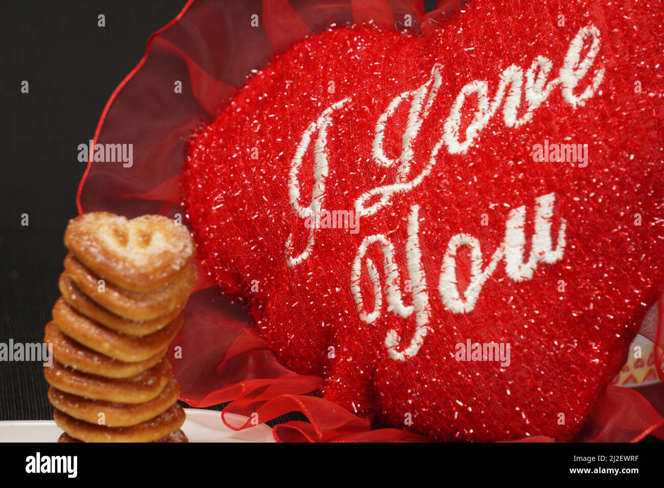 Very Close-Up, Hearts Shaped Biscuit Stack with Red Heart In Text I Love You Stock Photo