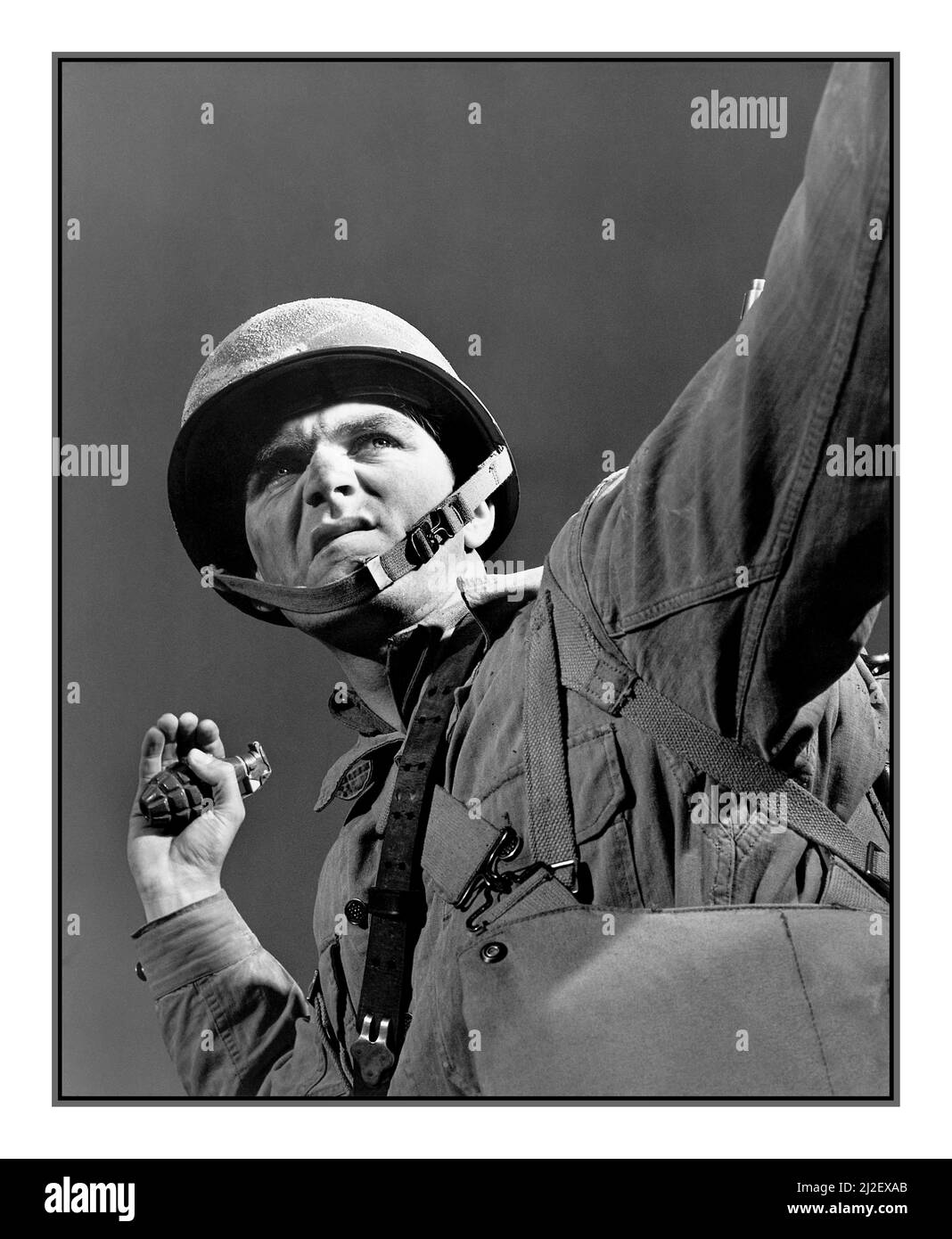 GRENADE THROWING WW2 American Propaganda Image 'A package for Hitler', Belvoir Virginia. Grenade throwers. An infantryman in training at Fort Belvoir, Virginia prepares to hurl a grenade. November 1942  Photographer Alfred T. Palmer World War II Second World War Stock Photo