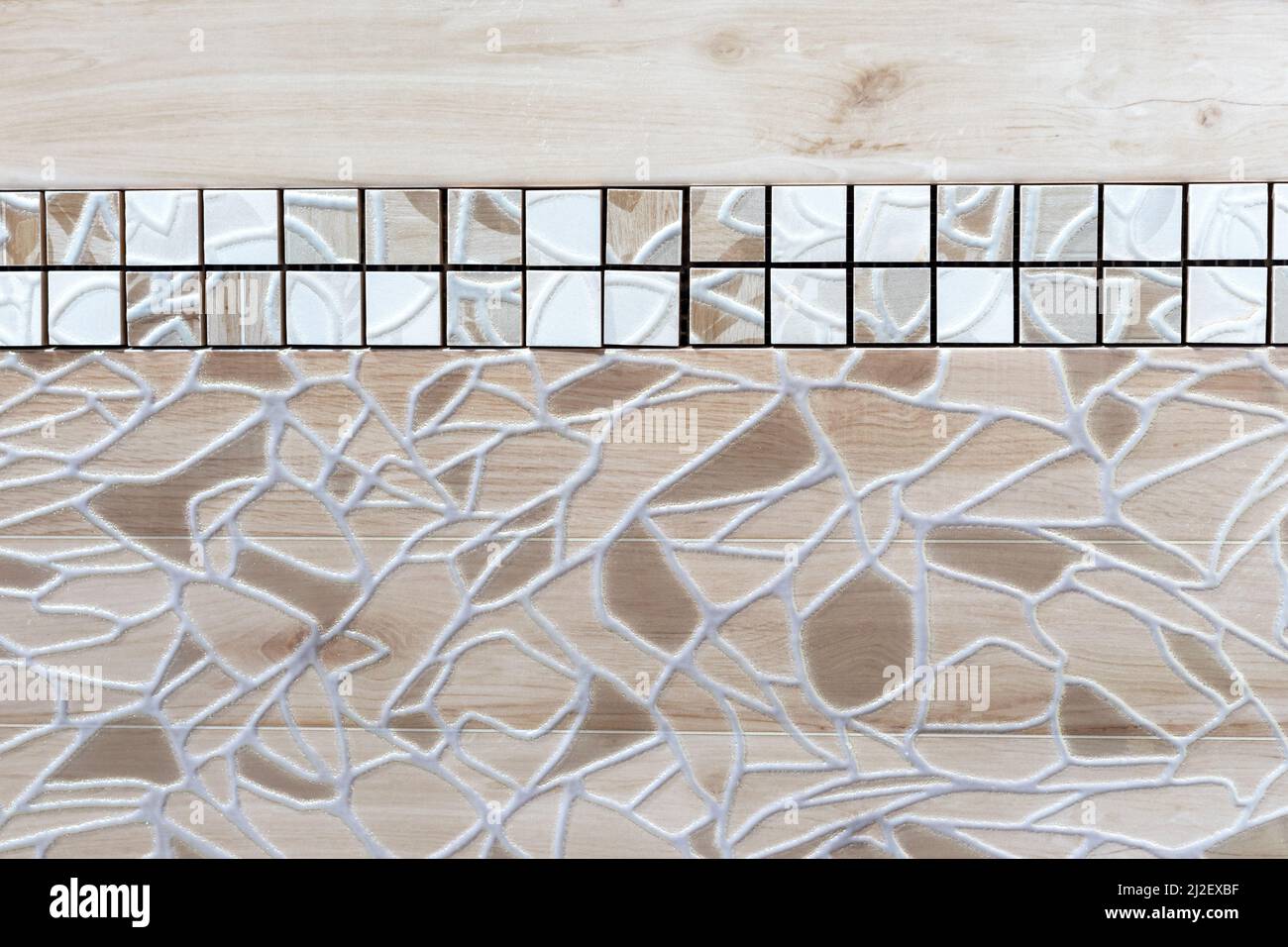Beige-brown ceramic tile with abstract pattern and border. Stock Photo