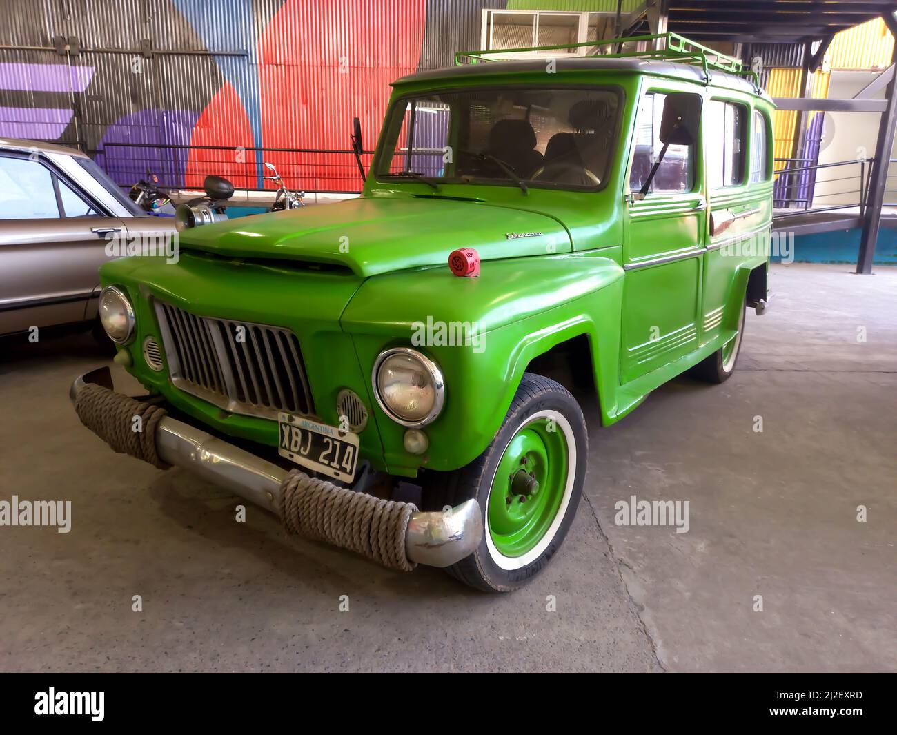 old green jeep IKA Estanciera ex Overland Willys Station Wagon circa 1966 parked in a warehouse yard. Classic car show. Stock Photo