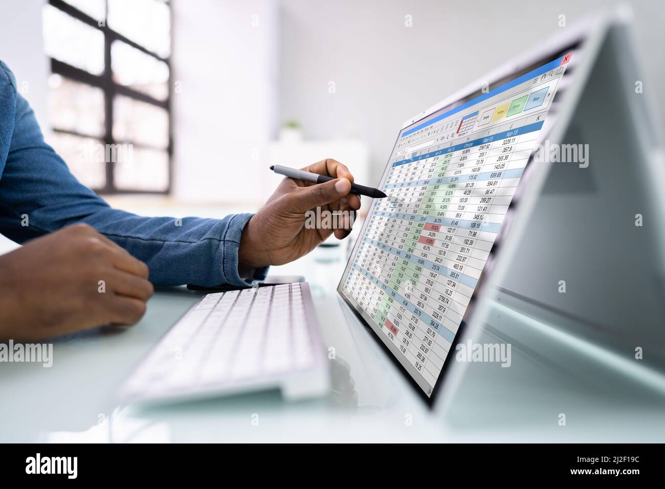 Electronic Spreadsheet Analyst Or Auditor Using Software On Hybrid Laptop Stock Photo