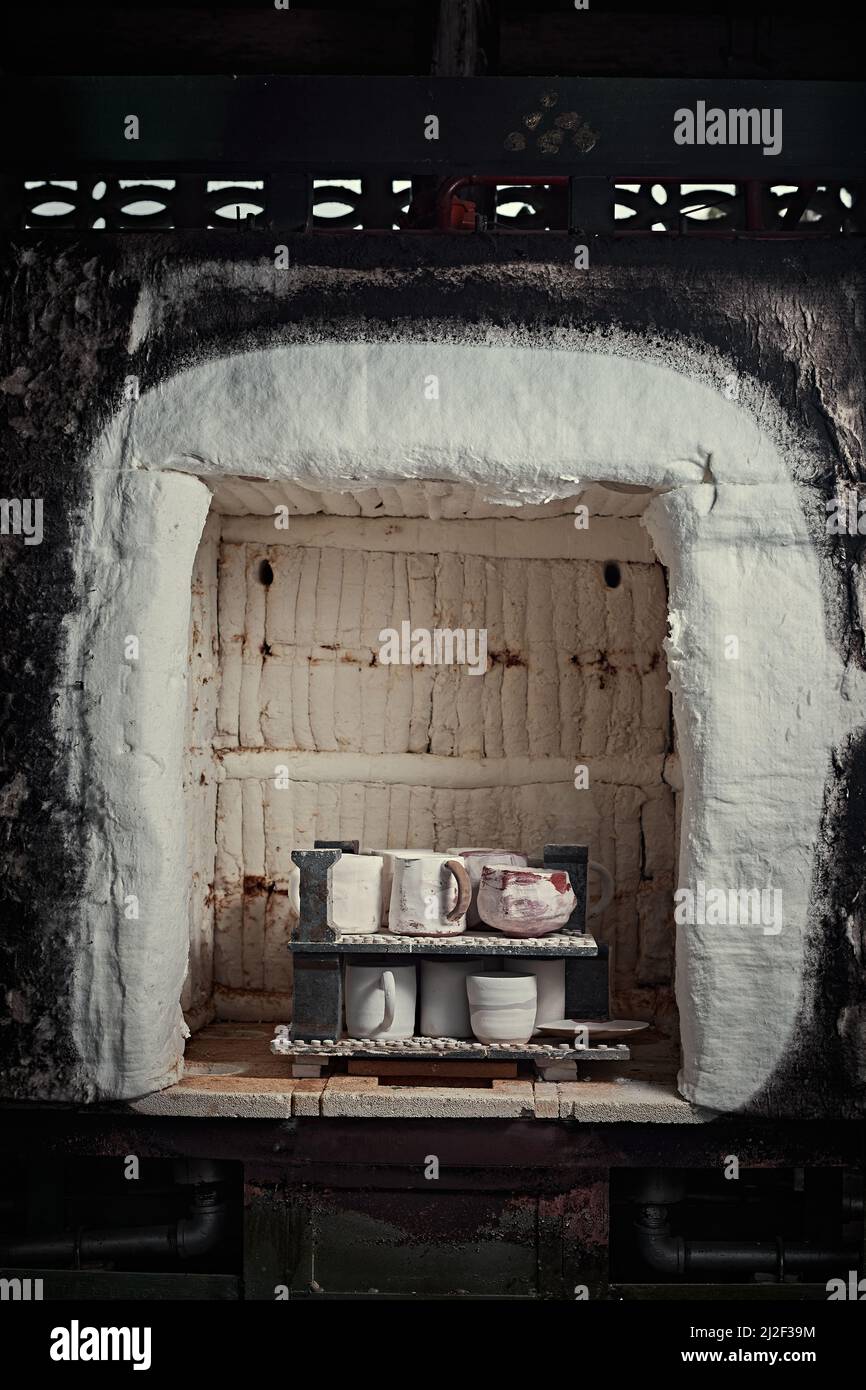 clay mugs in kiln for firing pottery in pottery studio Stock Photo Alamy