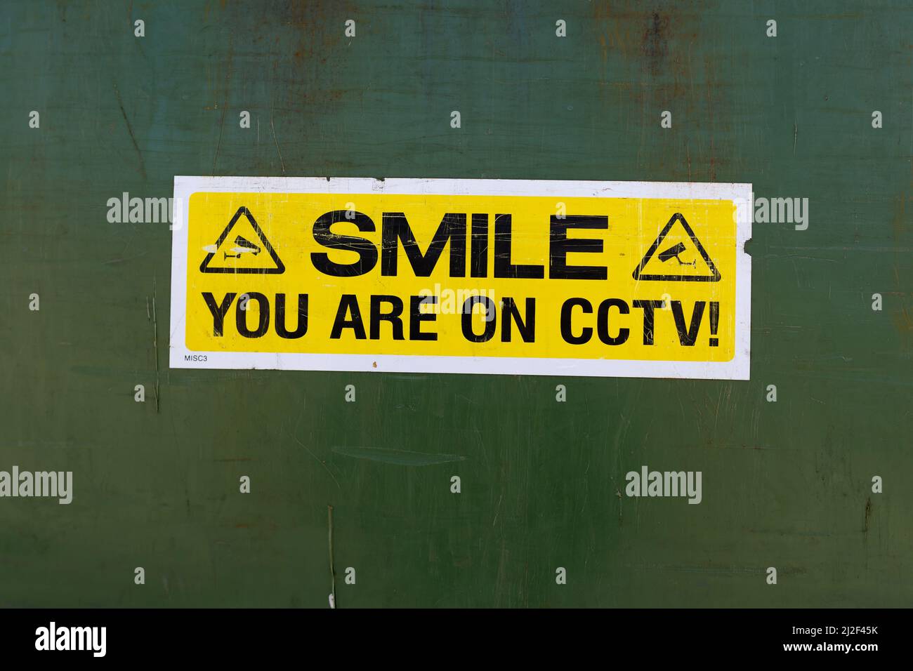 Bright yellow smile you are on CCTV sign warning the public they are being watched and recorded. Stop crime, anti social behaviour, security concept Stock Photo