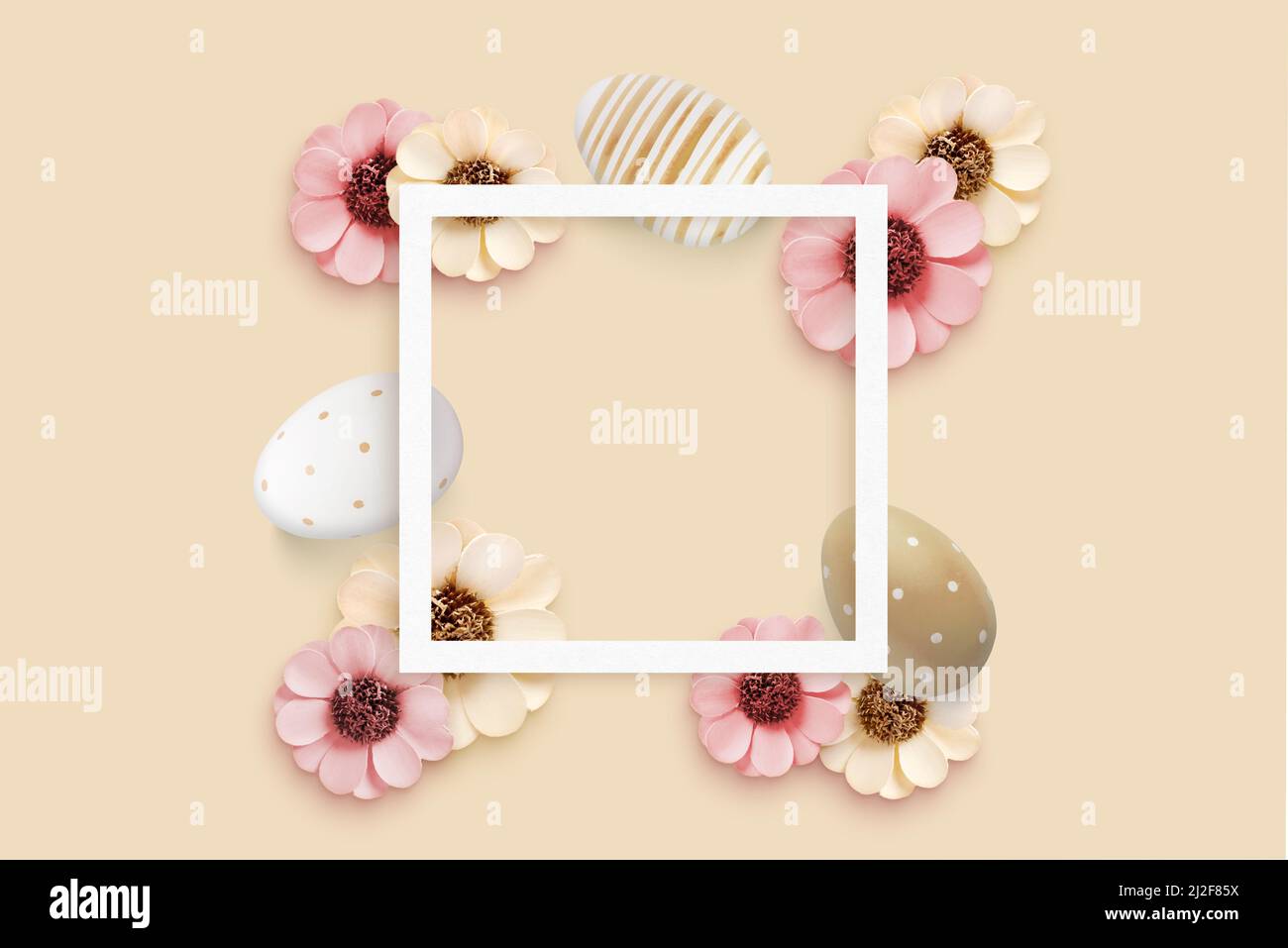 Square frame surrounded by Easter eggs and flower decorations. Copy space for greeting text. Top view, flat lay composition Stock Photo