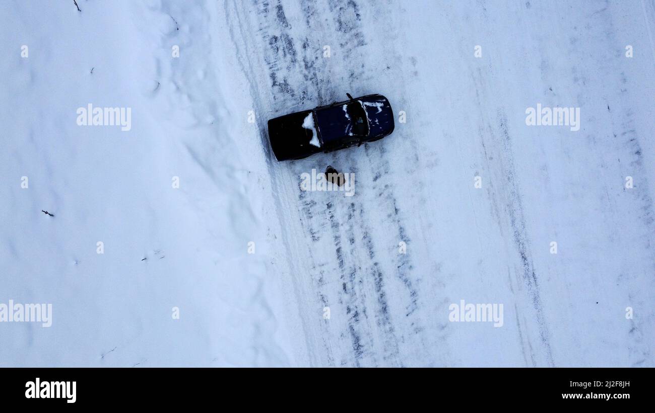 An aerial view of a car on the road covered in snow Stock Photo - Alamy