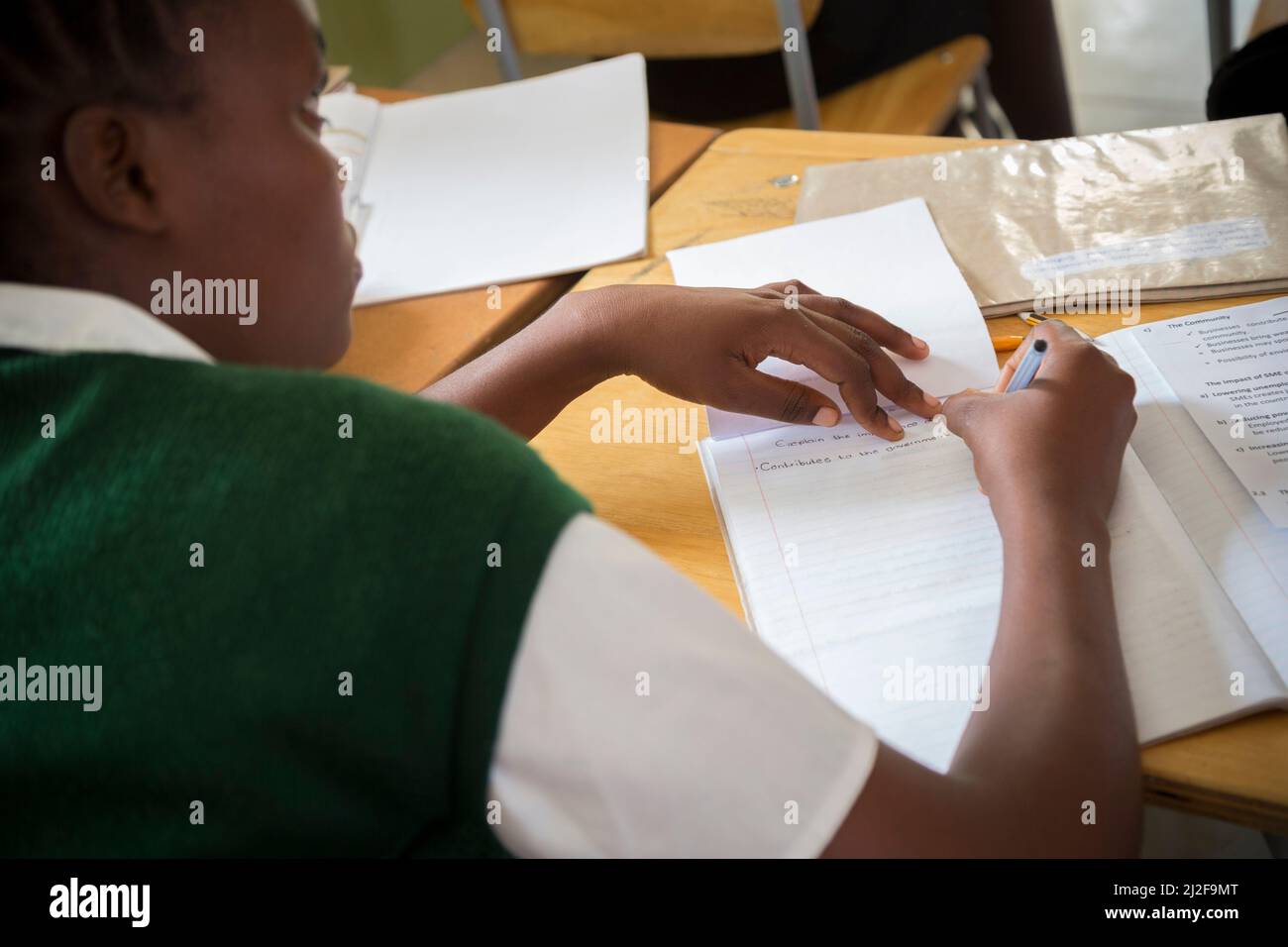 Secondary school students learning at desks in classroom in Oshana Region, Namibia, southern