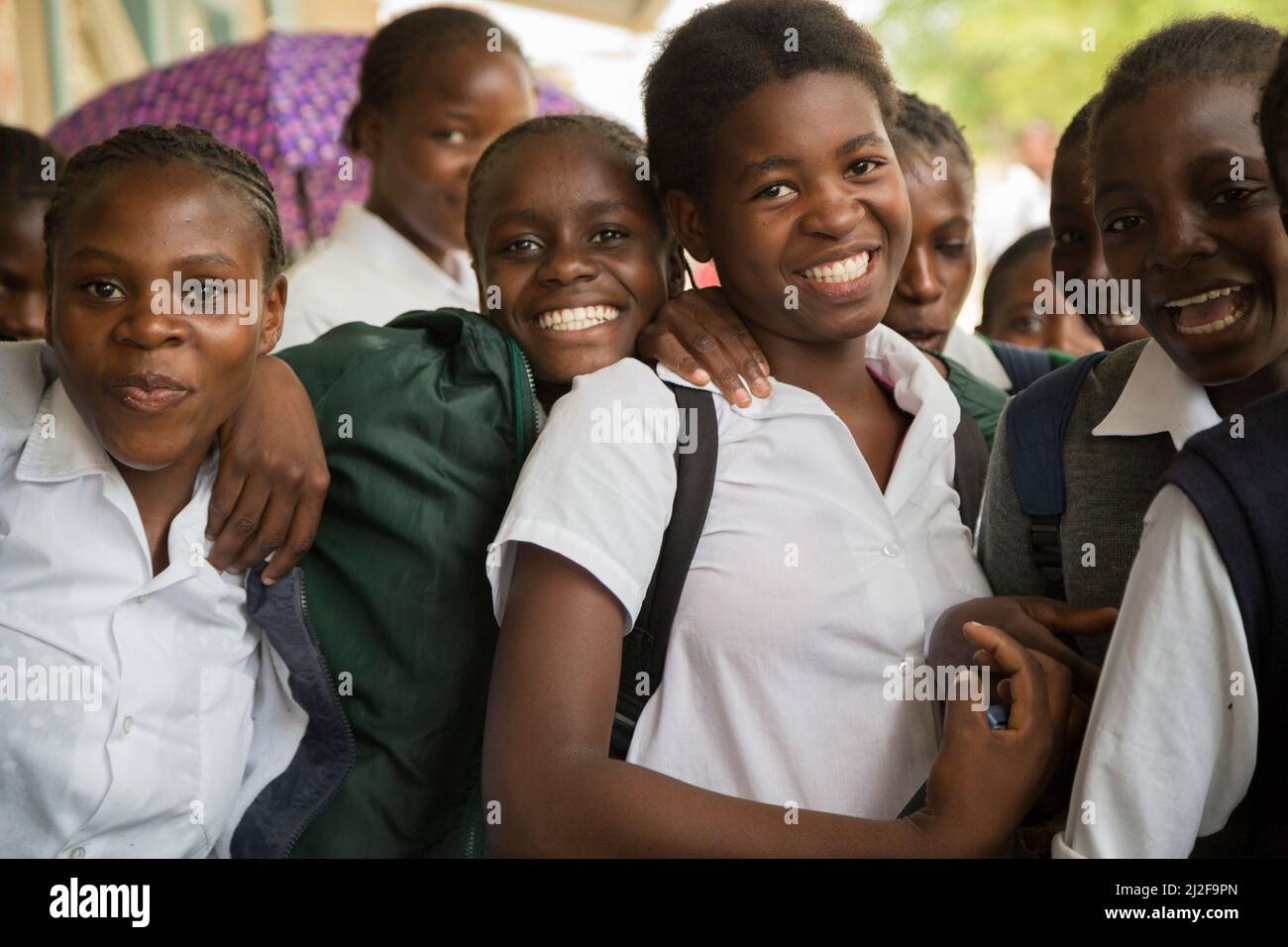 African female secondary students smiling together in their school courtyard in Oshana Region, Namibia, southern Africa. Stock Photo