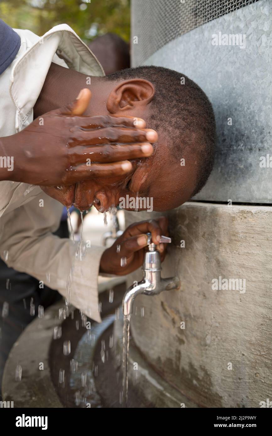 School students access clean drinking and washing water from a fountain